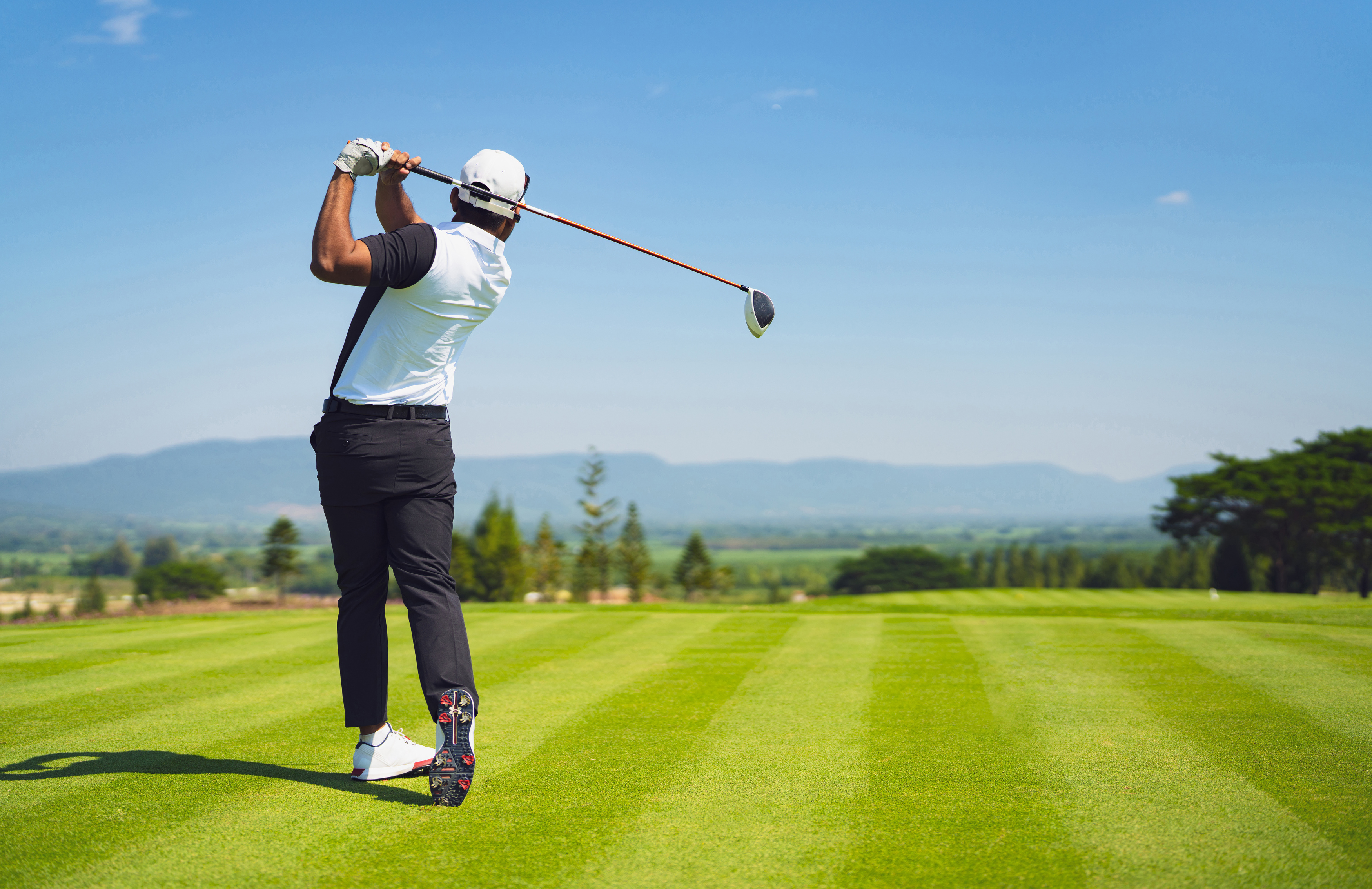 a man swinging a golf club